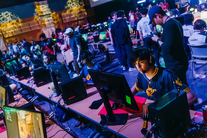 Students in a crowded hall for an esports competition