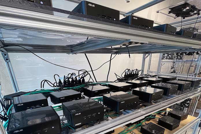 A cluster of ASUS NUC mini-PCs in a room that tests for mean time between failure 