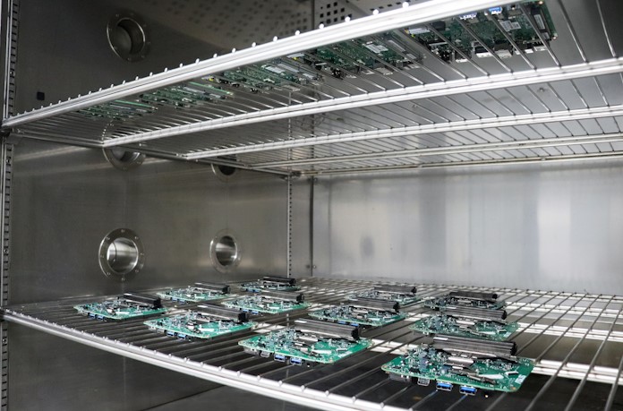 A cluster of ASUS NUC motherboards in a high-temperature test chamber