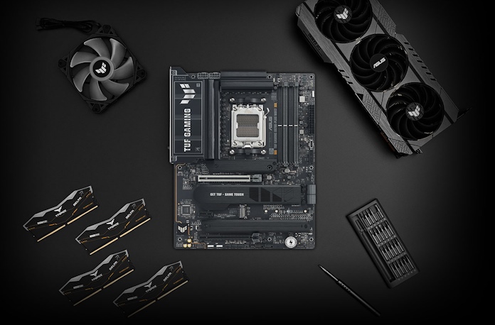The TUF Gaming X870E-Plus WiFi motherboard on a table with other PC building components
