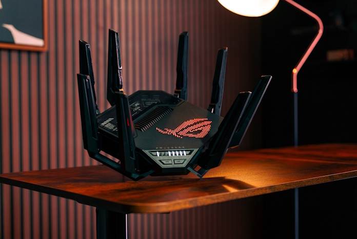The ROG Rapture GT-BE98 Pro router on an end table in a living space
