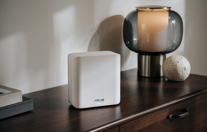An twooden table with a ZenWiFi BD4 mesh router on top with other decorative items