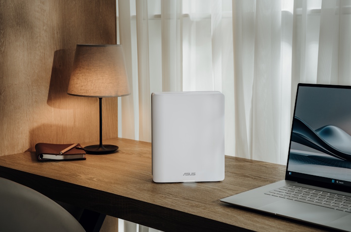 A ZenWiFi BQ16 Pro system on a desk with a PC