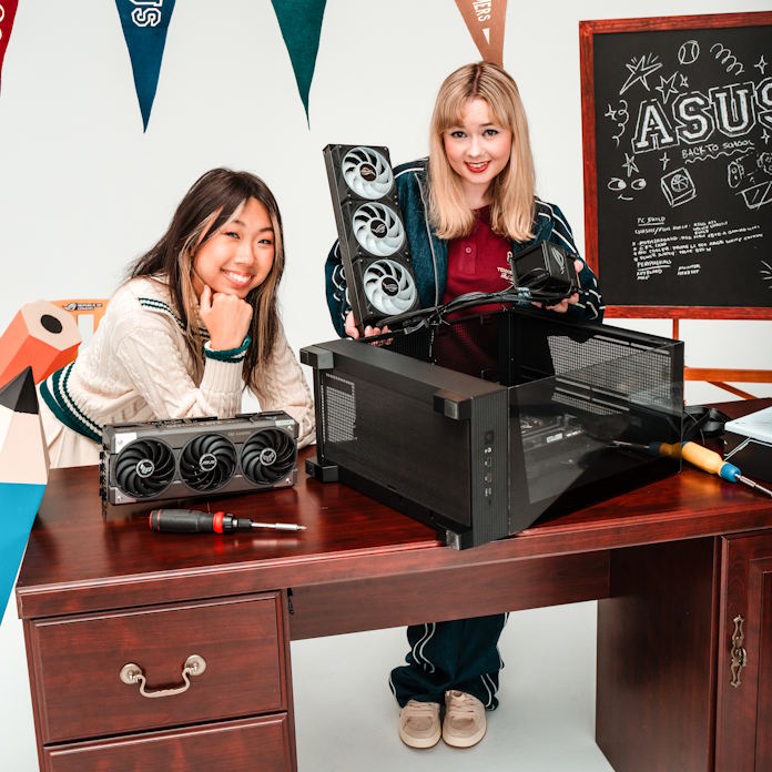 Two young women building a PC together