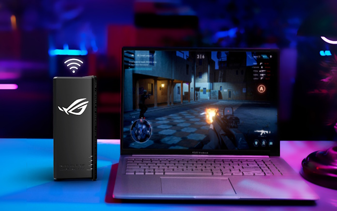 The ROG Strix GS-BE18000, a gaming router from ROG on a desk with an ROG laptop