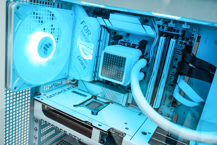 The interior of a PC focused on an ASUS Prime LC 360 ARGB LCD AIO CPU liquid cooler