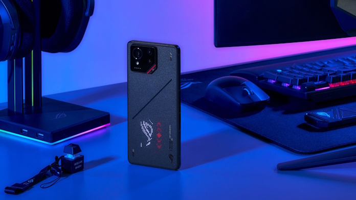 The ROG Phone 9 on a desk with other ROG gear 