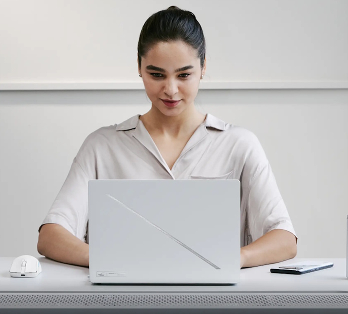 A young woman using an ROG Zephyrus G14 laptop 