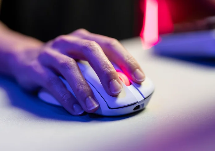 A gamer with his hand on the ROG Keris II Origin gaming mouse
