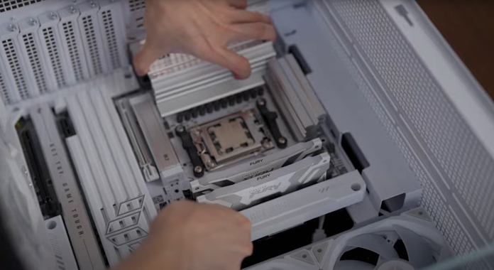 A motherboard being installed into a PC case