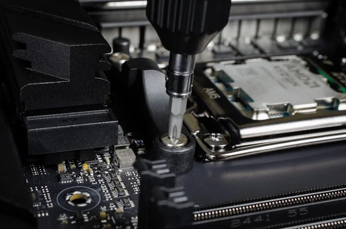 Removing the screws holding the preinstalled heatsink mounts in place