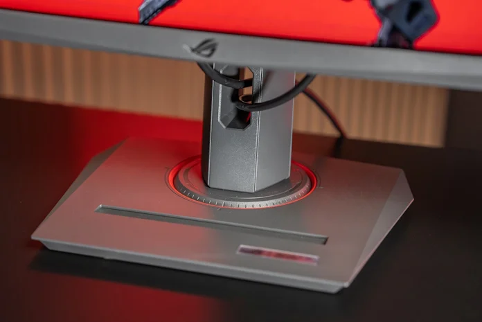 The stand of an ROG XG series gaming monitor, with an integrated smartphone holder