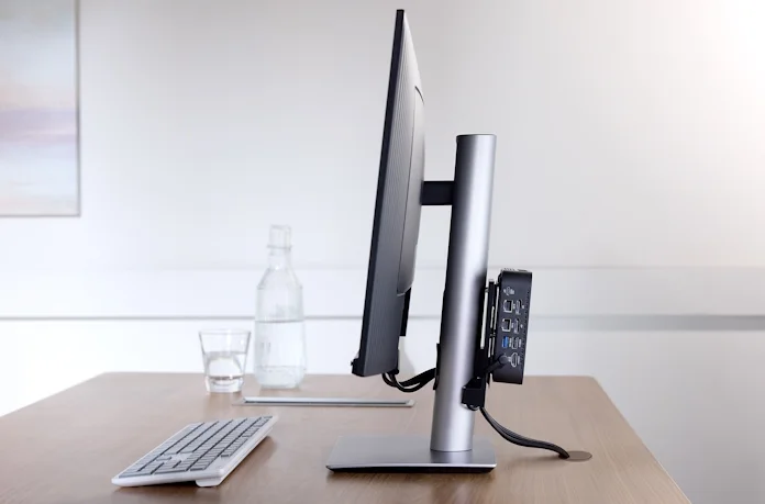 A NUC mounted to the back of a desktop monitor