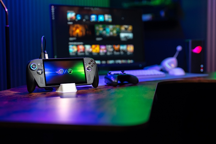 An ROG Xbox Ally X in a room with other gaming peripherals and gear from ROG