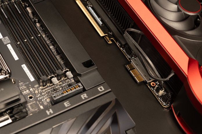 A BTF motherboard next to the ROG matrix GeForce RTX 5090, showing where the GC-HWPR connection draws its power