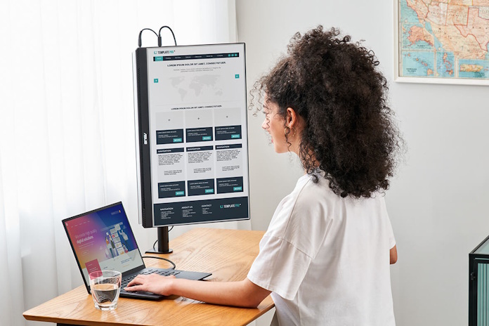 mb279cf - feature A woman uses the ZenScreen MB279CF in a portrait mode attached to a display stand