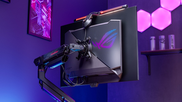An ROG OLED gaming monitor with both the ROG Ergo Monitor Arm and ROG Aura Monitor Light Bar 