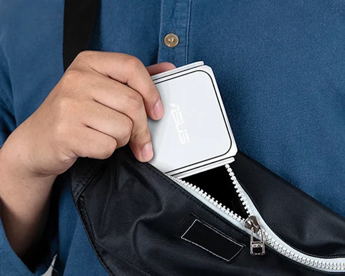 The ASUS RT-BE58 Go travel router being pulled out of a satchel