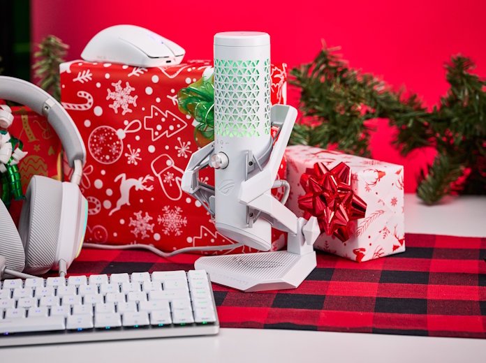 The ROG Carnyx gaming microphone on a table with presents and other white ROG peripherals