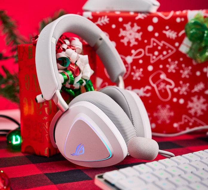 The ROG Delta II White leaning against a Christmas present with an ROG Falchion RX Low Profile keyboard in the foreground