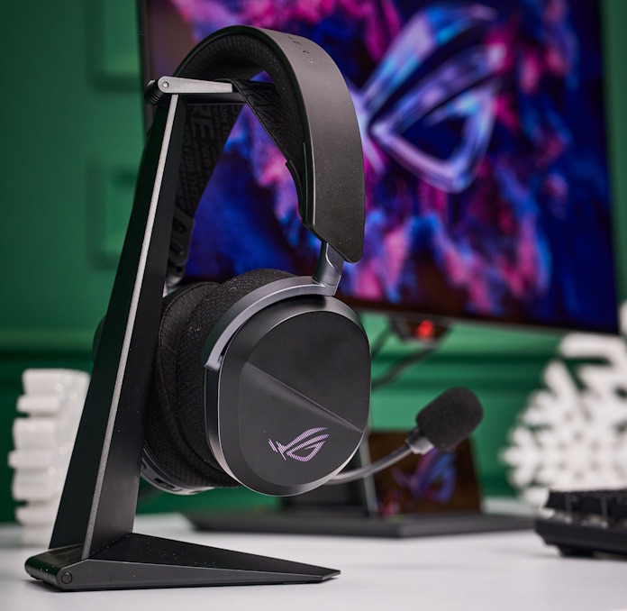 The ROG Pelta gaming headset hanging from a hook in front of a gaming setup