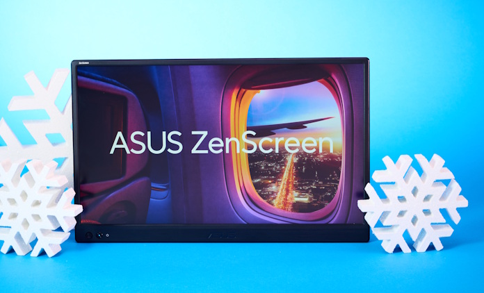 An ASUS ZenScreen portable monitor against a blue background with holiday decorations