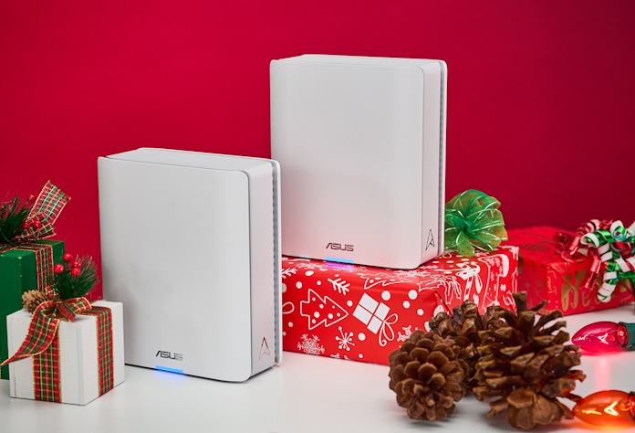 Two ASUS ZenWiFi mesh routers on an end table with wrapped presents