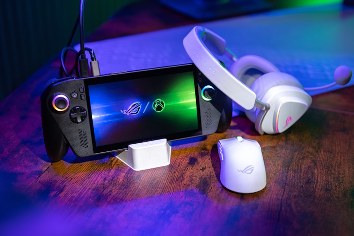 An ROG Xbox Ally X with ROG peripherals, hooked up to a gaming monitor and power adapter