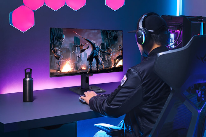 A gamer uses the ROG Strix OLED XG32UCDS gaming monitor