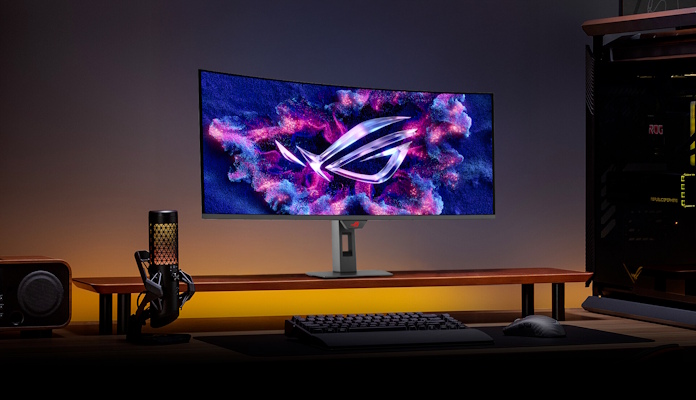 The ROG Strix OLED XG34WCDG gaming monitor on a desk with other ROG gear 