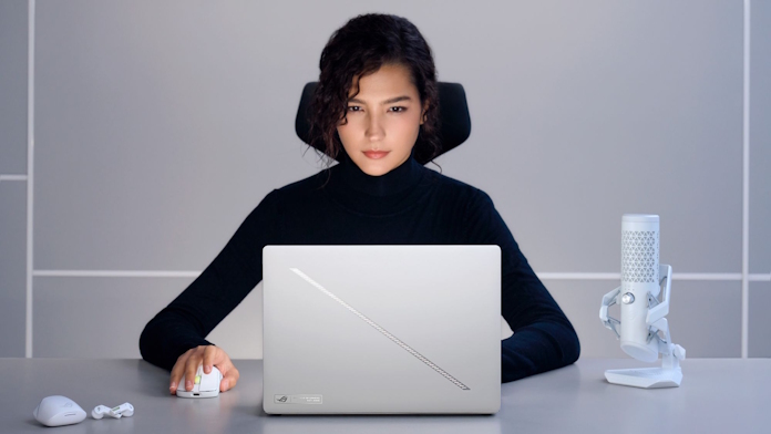 A woman at a desk using the ROG Zephyrus G16 gaming laptop